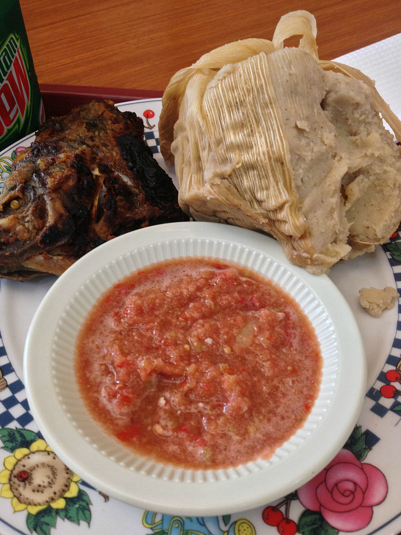 Kenkey (upper right) with fried fish and pepper