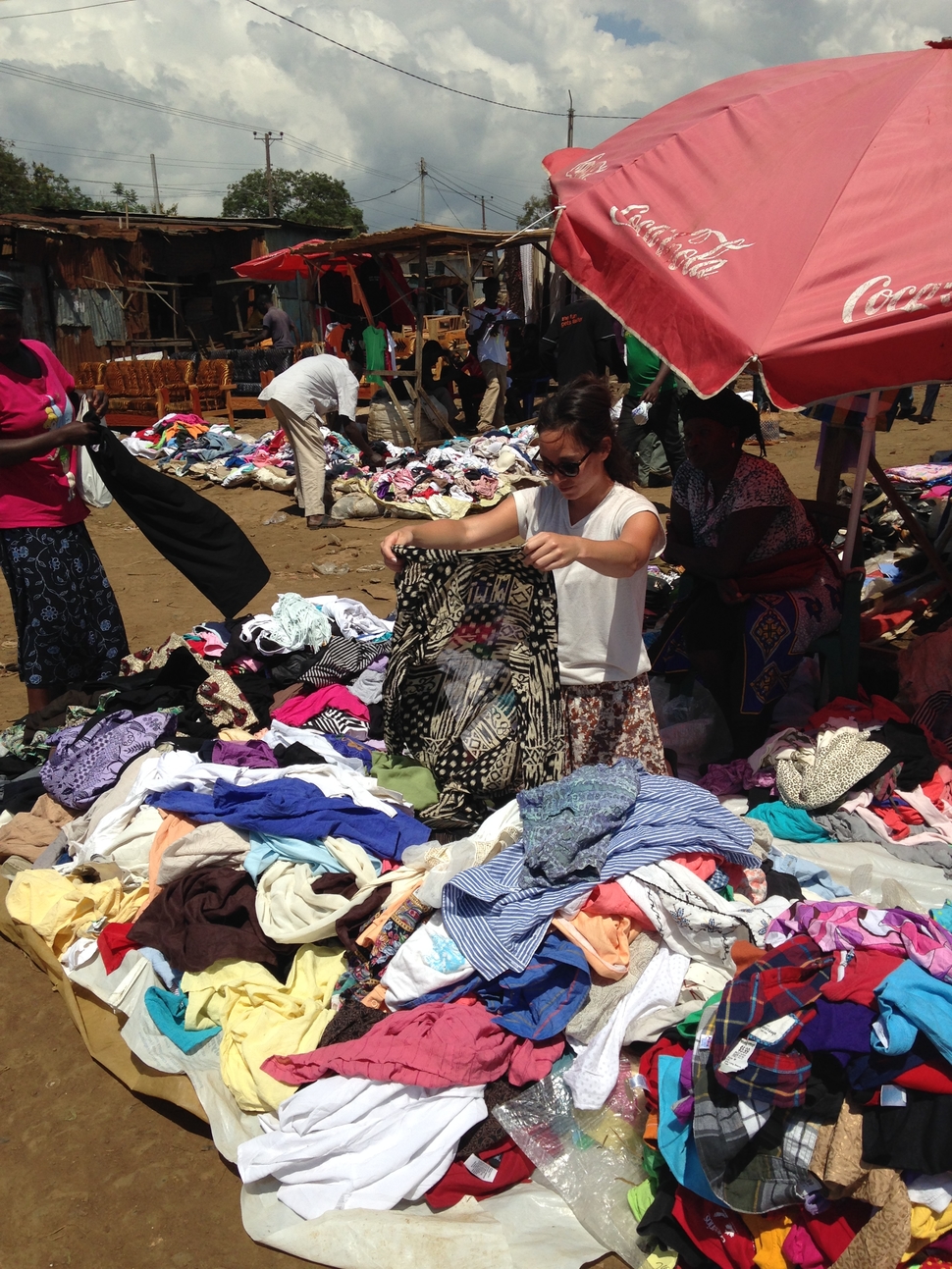 Simone selecting clothes at the market